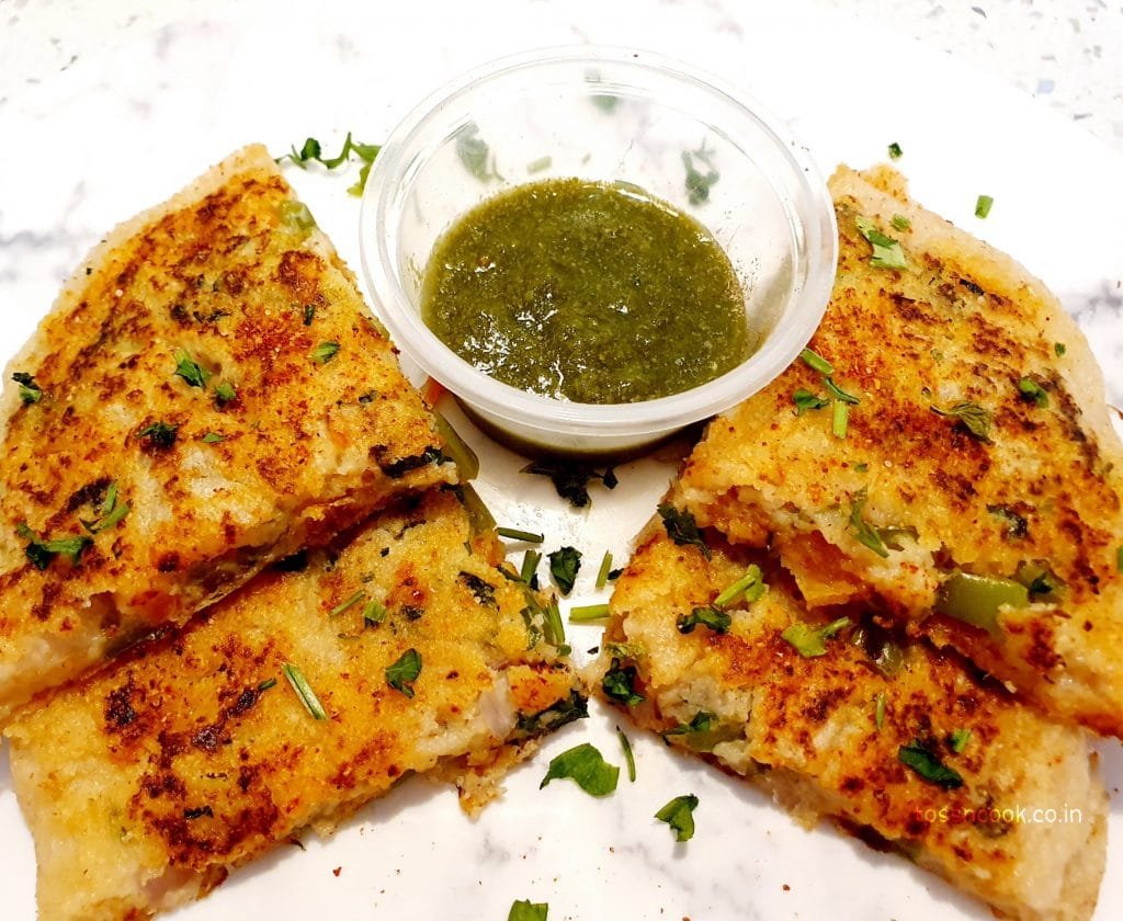 Top view Sandwich uttapam Top view image of four pieces of Sandwich Uttapam served with green chutney